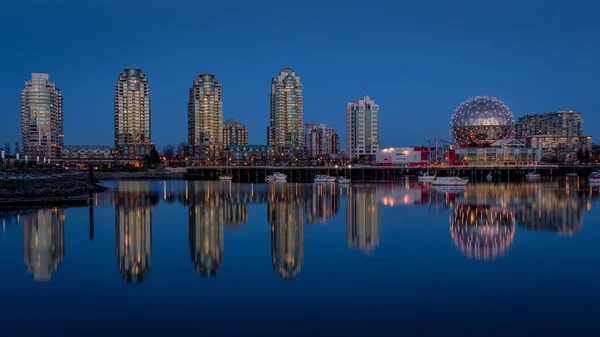 Vancouver Skyline at the Blue Hour with Lights on the Science Center Globe at night on the Eastern Shore of False Creek Inlet, British Columbia, Canada