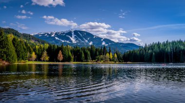 Lost Lake near the village f Whistler, with the ski slopes of Whistler Mountain in the background in British Columbia, Canada