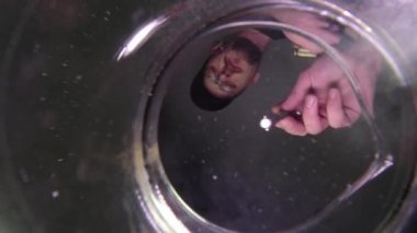 Kuyumcu gümüş yüzüğü sıvı bir banyoya daldırır. 