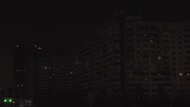 Dark apartment building with few lights  in Kyiv, Ukraine