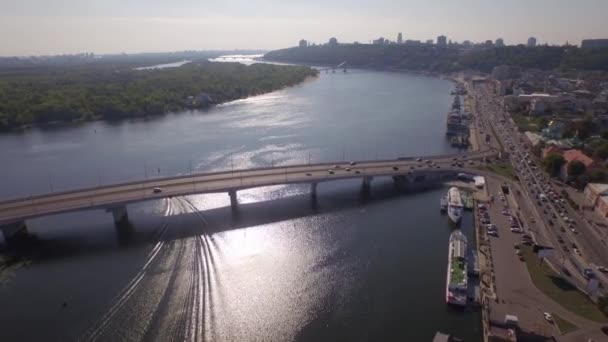 Aerial view on a traffic jam on the embankment of big river — Stock Video