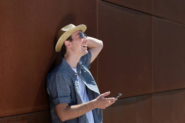 Gelukkig Jongeman Lachen Terwijl Het Houden Van Een Smartphone Tegen — Stockfoto