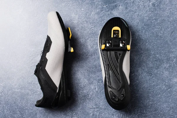 Pair of road cycling shoes with assembled automatic cleats for pedals.