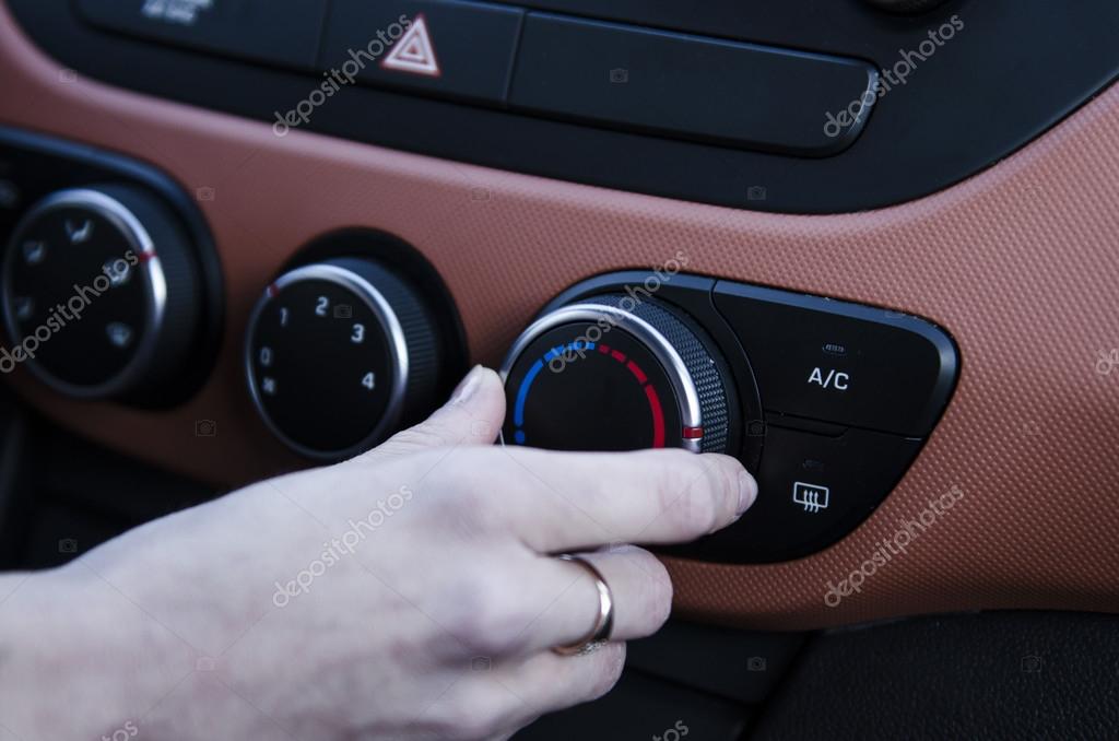 Turning on car air conditioning system Stock Photo by ©Marianarbh1
