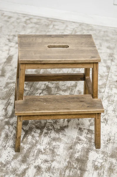 Natural wooden ladder and chair, isolated on wooden floor — Stock Photo, Image