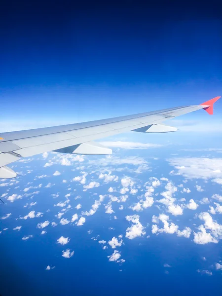 Top view from plane window to desert through clouds. View to sky. — Stock Photo, Image