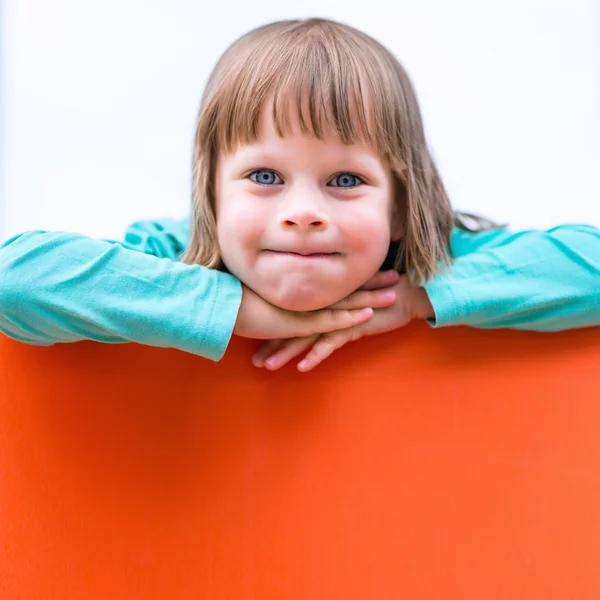 Girl child with orange board. Isolated portrait — Stock Photo, Image