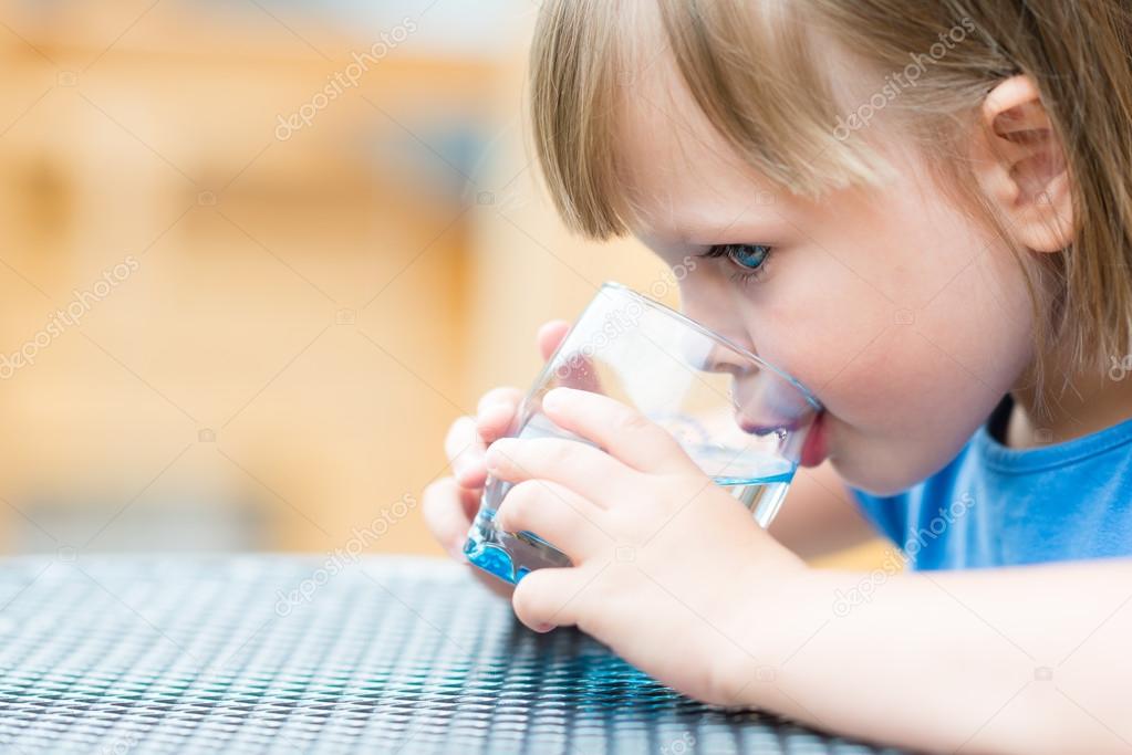 Girl drinking water outdoors