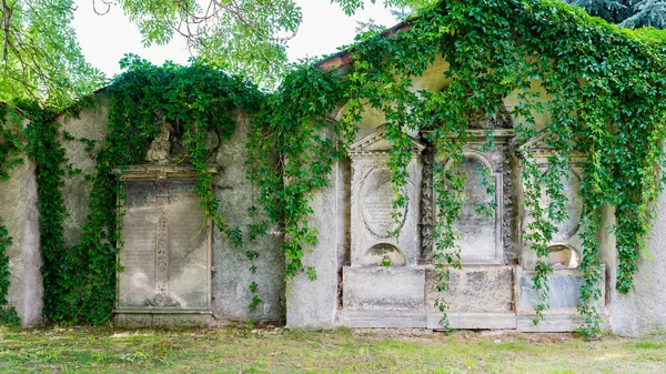 Stone tomb stele - a vertically positioned plate with an inscription or a relief stone decoration, also a vertical tombstone - placed on the fence of the church and cemetery