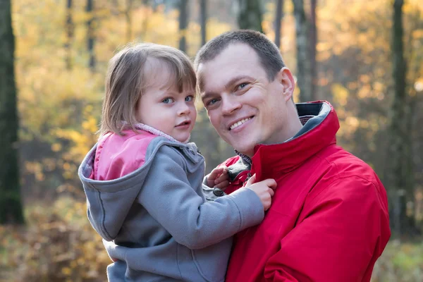 Father and daughter in autumn forest — Stock Photo, Image