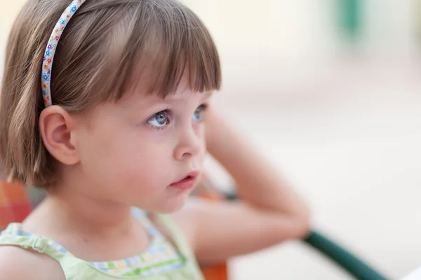 Cute little girl waiting for someone or something — Stock Photo, Image