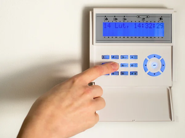 Pressing the code on a house alarm — Stock Photo, Image