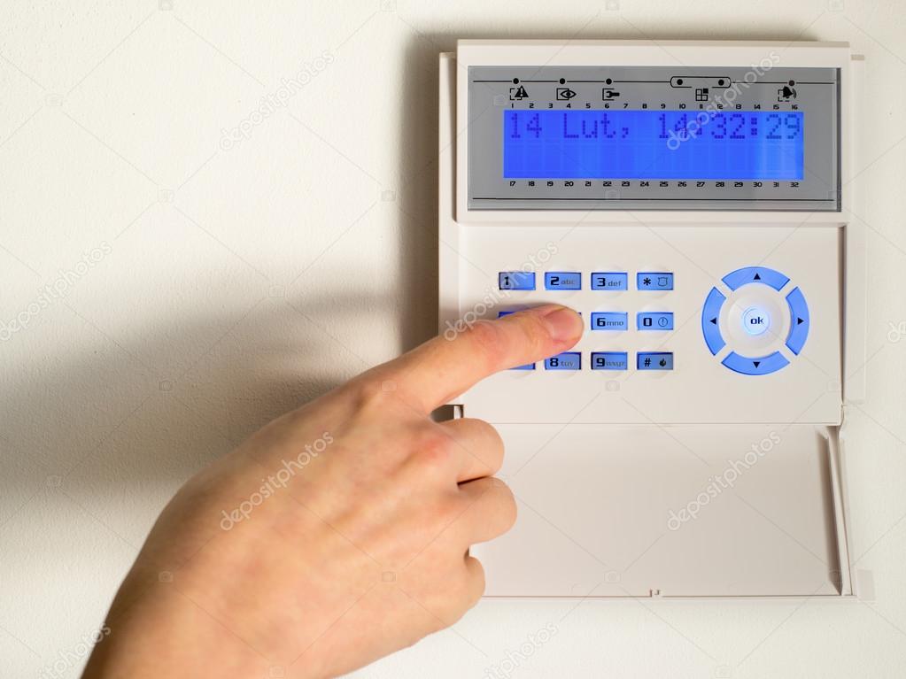 pressing the code on a house alarm 