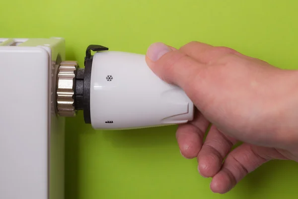 Radiator thermostat and hand - lemon — Stock Photo, Image