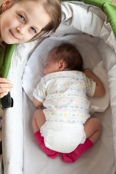 Older sister taking care of her younger sister — Stock Photo, Image