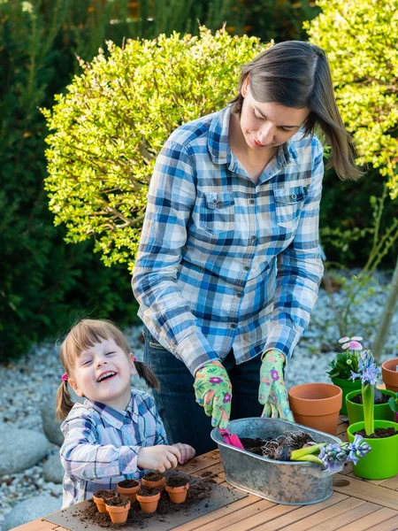 Fata plantarea bulbi de flori cu mama ei — Fotografie, imagine de stoc