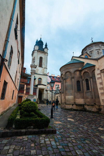 LVIV, UKRAINE: Rainy weather at town Market Square with lamposts and cobbled streets on. Lvivs Old Town is a part of UNESCO World Heritage List