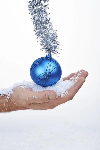 Blue Christmas ball with hand — Stock Photo, Image
