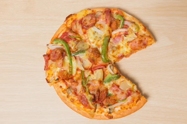 Pizza with sliced vegetables on wood — Stock Photo, Image