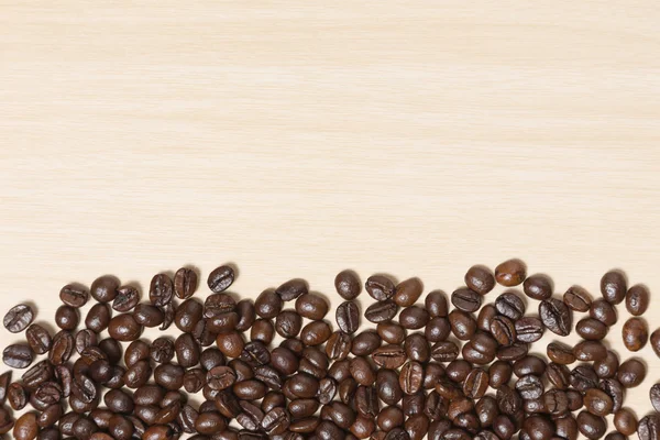 Coffee beans on wood table with copyspace for text — Stock Photo, Image