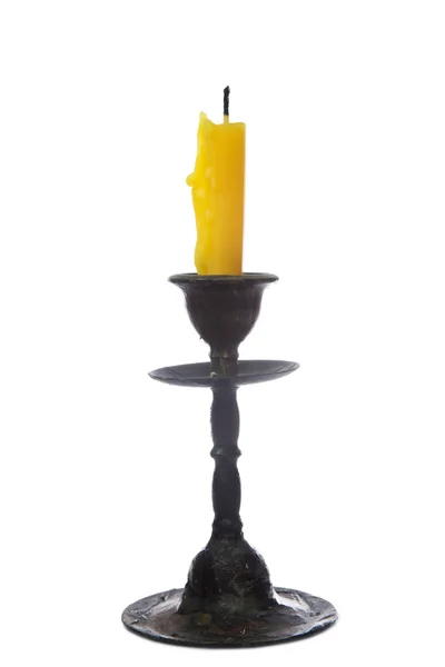 Old yellow candle in old bronze candlestick — Stock Photo, Image