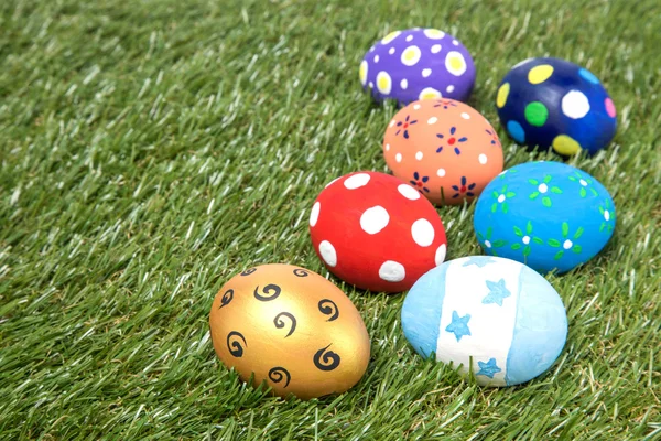 Coloridos huevos de Pascua hechos a mano sobre hierba verde — Foto de Stock
