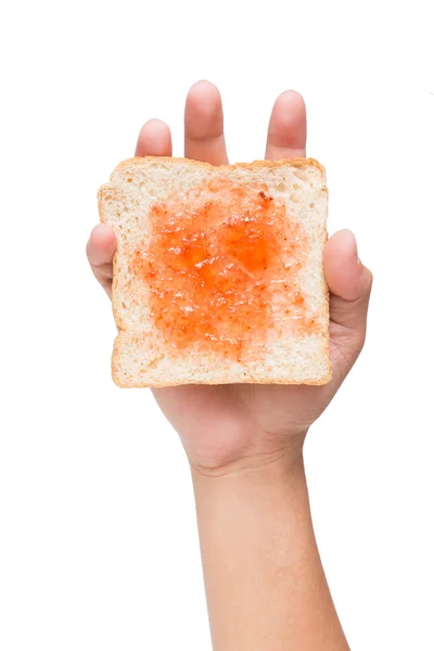 Mão segurando um pedaço de pão com geléia isolada em branco — Fotografia de Stock