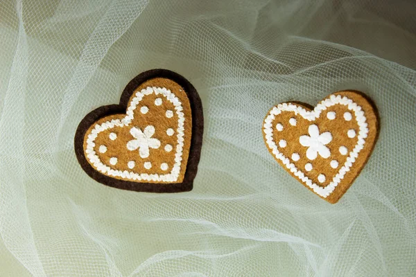 Sevgililer Günü için kalpleri ve çiçekleri olan pembe tekstil arka planında hatıra oyuncak ayılar.