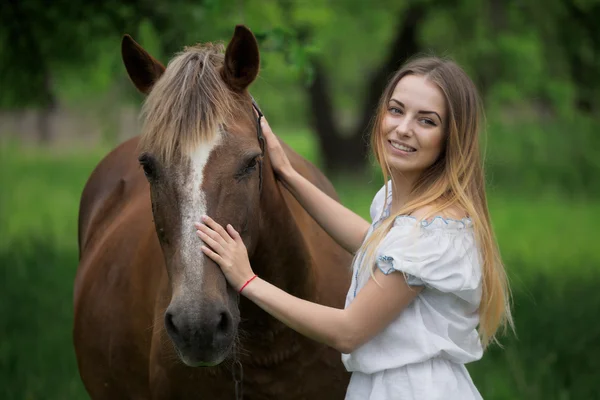 Outdoor portrait of young beautiful woman with horse — Stock Photo, Image