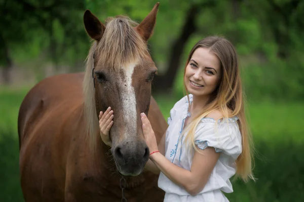 Outdoor portrait of young beautiful woman with horse — Stock Photo, Image