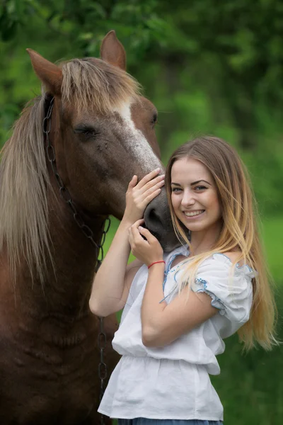 Outdoor portrait of young beautiful woman with horse — Stock Photo, Image