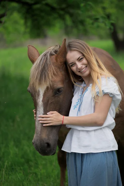Outdoor portrait of young beautiful woman with horse — Stock Photo, Image