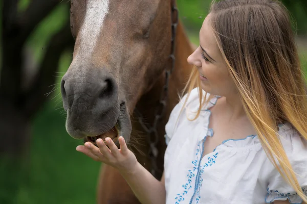 Outdoor portrait of young beautiful woman with horse — Stock Photo, Image