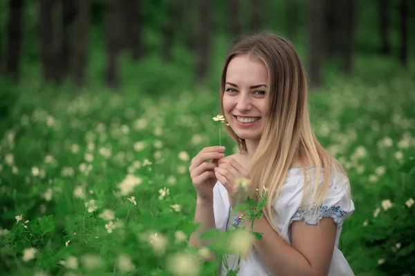 Beautiful young girl close-up in a white shirt, against a background of green forest — Stock Photo, Image