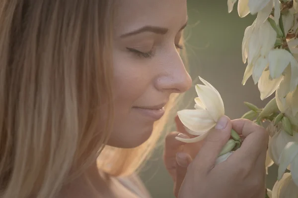 Portrait en gros plan.. Jeune belle jolie femme posant en robe longue contre dans le domaine avec des fleurs blanches — Photo