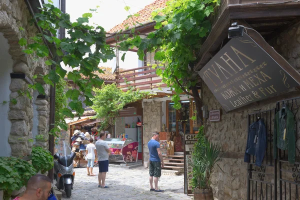 NESSEBAR, BULGÁRIA, JUNHO 18, 2016: turistas visitam as lojas de souvenirs nas ruas da cidade velha de Nessebar — Fotografia de Stock