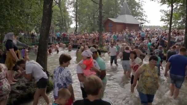 Slavgorod, weißrussland - 14. august: das blaue krynica. Massenwallfahrt zur Heilung in Honigbäder. Menschen tauchen in das eisige Wasser und gehen über den Bach am Feiertag Tradition 14. August 2016 in Slavgorod, Weißrussland . — Stockvideo