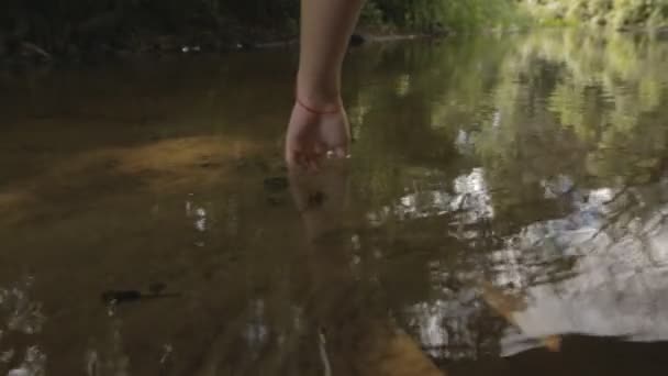 Κορίτσι σε ένα κοστούμι λουσίματος ξαπλωμένος σε μια αιώρα πάνω από το νερό — Αρχείο Βίντεο
