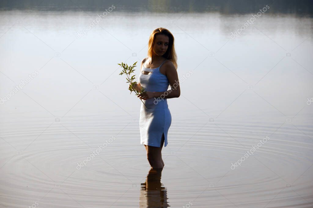 portrait of a girl by the water at dawn 2020