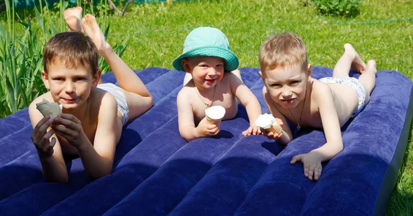 children sunbathe on the mattress and eat ice cream 2020