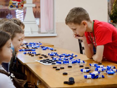 GOMEL, BELARUS - 27 Aralık 2020: Çocuklar arasında Yılbaşı Dama Turnuvası. Şeker 2020 şampiyonlarıyla eş zamanlı oyun