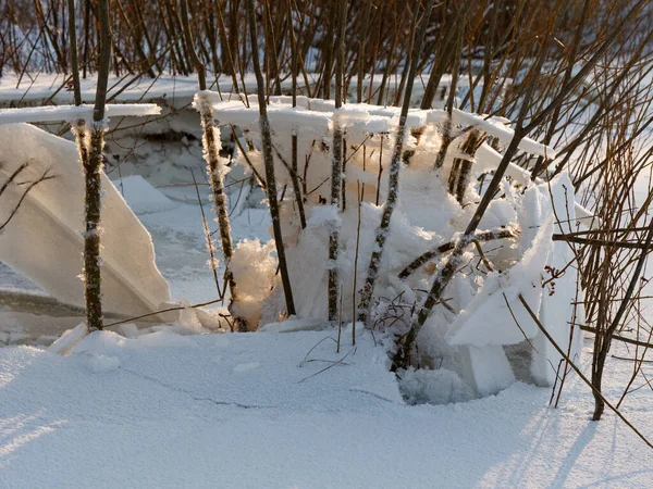 broken ice near the river bank in the cold. lower water levels break ice 2021