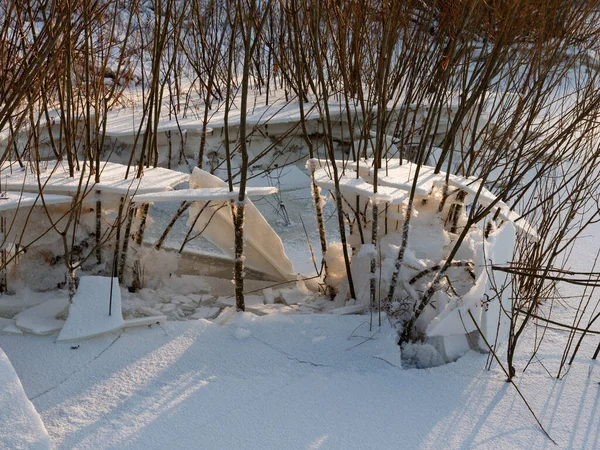 broken ice near the river bank in the cold. lower water levels break ice 2021