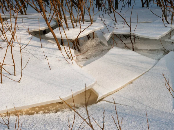 broken ice near the river bank in the cold. lower water levels break ice 2021