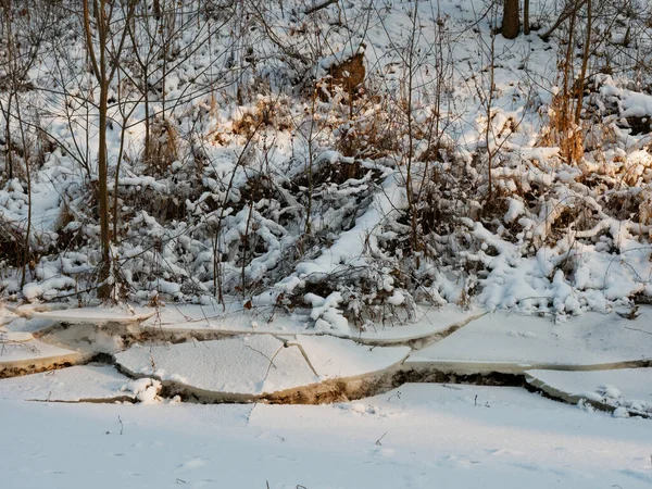 broken ice near the river bank in the cold. lower water levels break ice 2021