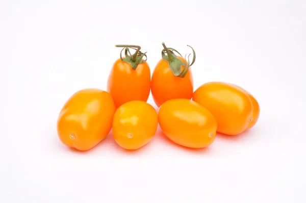 Gele tomaten op witte achtergrond Stockfoto