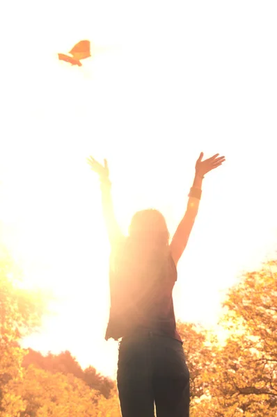 Silhouette of an happy woman at forest background