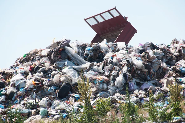 Landfill near crop fields and small city. Enormous Trash wave near fields — Stock Photo, Image