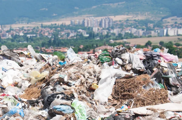 Landfill near crop fields and small city. Enormous Trash wave near fields — Stock Photo, Image