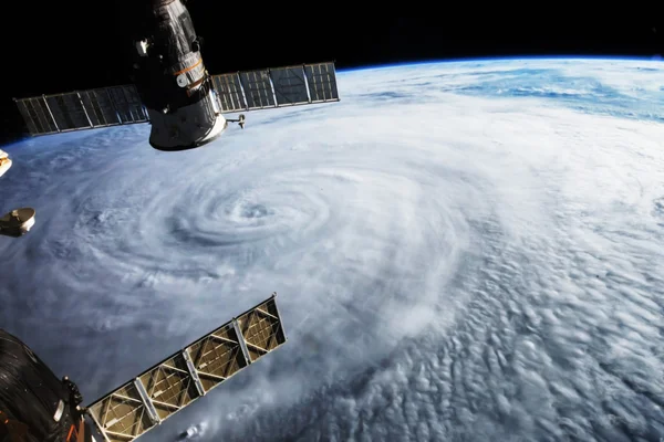 Satellite above hurricane on earth. Some graphics are provided by NASA. — стокове фото